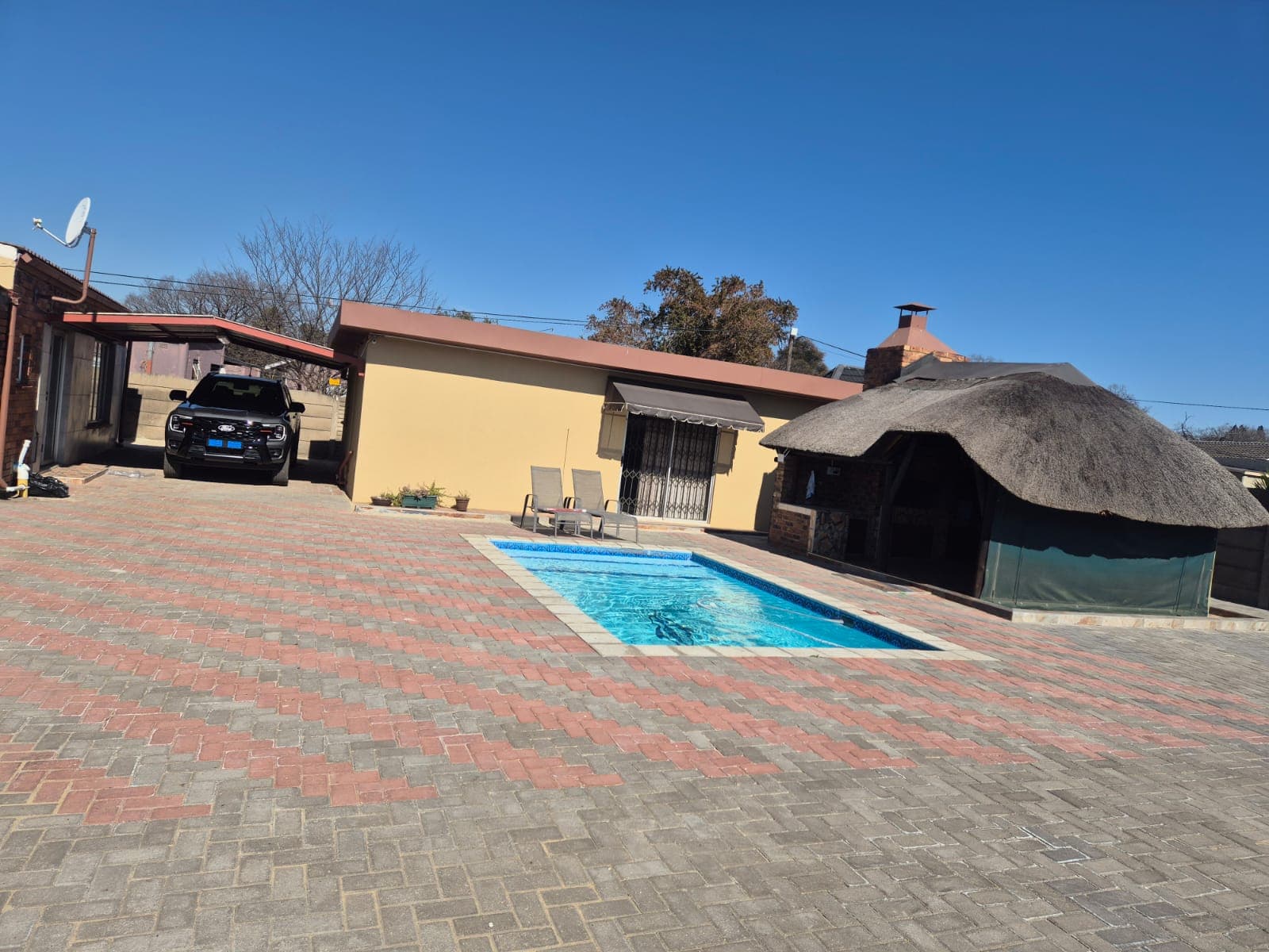 BK Guest Lodge's pool, braai lapa, and secure parking on a clear Vanderbijlpark afternoon